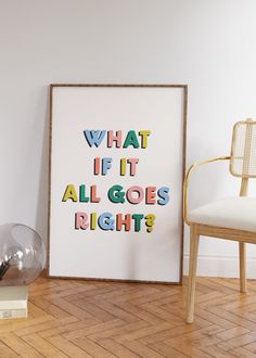 a framed poster with the words what if it all goes right? next to a chair