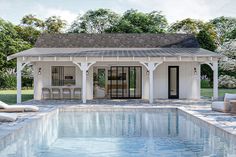 a pool house with lounge chairs around it