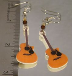 "Dangle Earrings featuring print art of an accoustic guitar. Handmade Altered art Made with resin, quality base metal connectors and surgical steel ear wire. Highlighted with glass beads. Measure 2 3/4\" long. Extremely lightweight! Barely can feel them. Pay one low shipping price for all items ordered. US orders ship for $3.50 Visit www.afanaffair.com or the 'Wearable Memories' shop section on Etsy to find out how to put your own photos on jewelry Like us on facebook for money saving coupons an Nickel-free Music-themed Jewelry For Concerts, Rocker Girl, Girls Music, Music Jewelry, Photo Pendant, Girl Jewelry, Daughter Birthday, Stainless Steel Necklace, Ear Wire