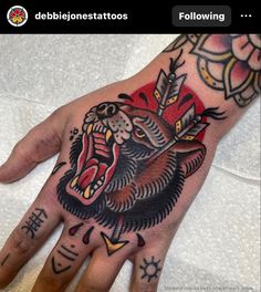 a person's hand with tattoos on it