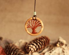 "Our handmade Reversible Jewelry collection features a striking wood-resin pendant in the shape of a tree of life, making it the perfect gift for nature lovers. This elegant and graceful necklace is a unique and meaningful gift for your boyfriend or someone special on their birthday or anniversary. Each wood resin pendant is handmade with unique wood grains and resin patterns making each piece one of a kind. The tree of life symbolizes growth, strength and balance, making this necklace a wonderful symbol of nature's beauty and importance. With its special design and quality craftsmanship, our special necklace and wonderful pendant will definitely amaze you. 💬 Explanation: In our workshop, every piece has a story behind it. Our creations are sometimes inspired by our own imagination, and o Spiritual Natural Color Necklaces As Gift, Artisan Necklace In Natural Wood As A Gift, Artisan Necklaces In Natural Wood As Gift, Artisan Natural Wood Necklace As A Gift, Artisan Natural Wood Necklaces For Gift, Nature-inspired Natural Color Jewelry As A Gift, Spiritual Natural Wood Necklaces As Gift, Natural Wood Spiritual Necklaces For Gifts, Spiritual Natural Wood Jewelry Gift