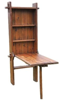 an old wooden table with a book shelf on it's back end and legs