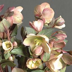 a vase filled with lots of flowers on top of a wooden table next to a gray wall