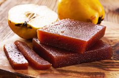 pieces of fruit sitting on top of a wooden cutting board