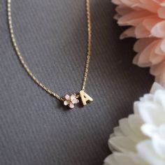 Personalized Cherry Blossom and initial necklace in gold. ▶▶ You can also add more letters from following link. https://www.etsy.com/listing/229265692/brushed-finish-letters-alphabet-monogram ▶ Material - Gold plated over brass ▶ Chain Length - 14 ~ 20 inches adjustable. ▶ Measure - Flower 6mm Letter H 7mm x W. 5mm ▶The matching bracelet available from following link. https://www.etsy.com/listing/191406481/cherry-blossom-bracelet-pink-flower https://www.etsy.com/listing/842121728/personalized-ch Cute Necklaces For Wedding On Mother's Day, Personalized Flower Pendant Jewelry For Bridesmaid, Pink Initial Pendant Necklace As Gift, Pink Initial Pendant Jewelry Gift, Pink Initial Pendant Necklace For Gift, Pink Dainty Jewelry For Personalized Gifts, Pink Initial Pendant Jewelry For Mother's Day, Dainty Pink Jewelry For Personalized Gift, Personalized Flower Pendant Necklaces For Bridesmaids