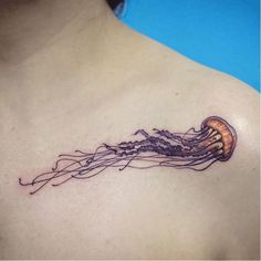 a woman's chest with a tattoo of a jellyfish