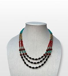 Step into the world of boho chic with our Bohemian Dreams Handcrafted Beaded Multi-Strand Necklace, a perfect blend of free-spirited style and elegance. Features: Intricate Beadwork: Black, red, turquoise, and golden beads are thoughtfully arranged to create a vibrant, captivating design. Adjustable Length: The necklace features an adjustable hook clasp, allowing you to customize the length for any outfit or occasion. Versatile Style: Ideal for both casual and formal wear, this statement piece complements a wide range of looks. Artisan Craftsmanship: Handcrafted by skilled artisans, each necklace is a testament to their dedication and attention to detail. Size & Material: Material: High-quality beads with a sturdy link chain Style: Multi-strand, adjustable length Care Instructions: Store i Spiritual Black Beaded Jewelry For Beach, Spiritual Black Beads Jewelry For Beach, Bohemian Black Beads Jewelry, Festive Artisan Adjustable Beaded Necklaces, Bohemian Necklaces With Faceted Beads For Beach, Bohemian Faceted Beads For Festive Occasions, Bohemian Necklace With Faceted Beads For Beach, Turquoise Beaded Necklaces With Black Beads For Festival, Bohemian Beach Necklace With Faceted Beads