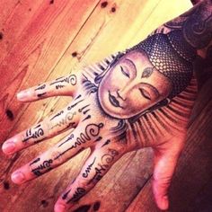 a person's hand with tattoos on it