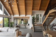 a living room filled with furniture next to a staircase