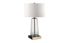 a table lamp with a white shade on the base and a gold frame around it