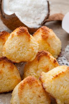 coconut macaroons on a baking sheet with powdered sugar in the background and text overlay that reads, coconut macaroons