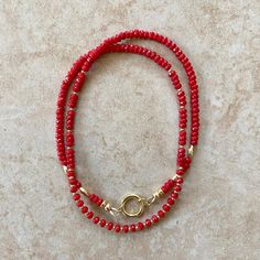 Beautiful red coral rondel beads necklace adorned with gold spacer beads and a gold charm clasp. The clasp allows you to wear one or more charms at a time or none. Length 18" Red coral has been used as a symbol of courage for decades. It’s a stone that symbolizes joy, abundance, protection, and prosperity. This stone will focus your energies on the pursuit of your goals. Root chakra -This information is intended for spiritual support only- Beads 3mm Spacer 2mm Spacer oval 6x3mm Findings 14K GF Red Gemstone Beaded Necklaces In Rondelle Shape, Red Rondelle Single Strand Beaded Necklace, Gold Beaded Necklaces With Red Coral Round Beads, Red Double Strand Beaded Necklace With Faceted Beads, Red Rondelle Beaded Necklace Single Strand, Gold Beaded Necklaces With Red Coral, Red Double Strand Gemstone Bead Necklaces, Red Coral Necklace With Gold Beads, Red Double Strand Faceted Beaded Necklaces