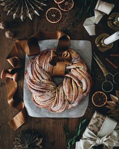 a round cake on a table with ribbon around it