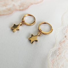 "✔️Star Hoop earrings made of 24K gold plated brass ✔️ This listing is for a pair of earrings - (2-star hoops) Modern & minimalist hoop earrings with a star-shaped charm. ✔️ So dainty and easy to put in ✔️ A very elegant and dainty pair of star charm earrings that upgrade your everyday look. These hoop earrings look beautiful layered with other gold earrings or even worn alone for a minimal look. They're tiny perfect for a child or for an adult. That's why they are considered your best choic Gold Hoop Earrings With Star Charm As A Gift, Handmade Gold Star Hoop Earrings, Gold Hoop Earrings With Star Charm For Gift, Gold Star-shaped Hoop Earrings With Ear Wire, Gold Hoop Earrings With Star Charm, Small Gold Hoop Earrings With Star Charm, Everyday Gold Star-shaped Hoop Earrings, Gold Plated Star Shaped Hoop Earrings, Gold Star-shaped Huggie Earrings As Gift