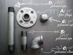 an assortment of metal fittings and tools laid out on top of a piece of steel