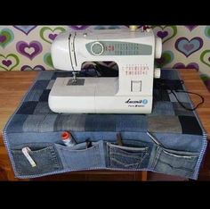 a sewing machine sitting on top of some jeans