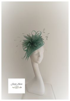 'Striking, elegant headpiece in mint green, sea green, sage green  sinamay.  Inspired by the 'bird of paradise' flower. This dramatic headpiece is made of 3 separate  petals with elongated tips.  An abundance of sage goose feathers protect a central bow, green coq feather tips dance in the breeze.    Sits on a headband 'This item has sold, however, similar pieces can be made in a variety of colours.  Please ask for details.  As every piece is handmade, some differences can occur from the photos Green Short Brim Fascinator For Evening, Evening Green Mini Hat With Short Brim, Evening Mini Hat With Short Brim In Green, Green Short Brim Mini Hat For Formal Events, Fitted Green Costume Hats And Headpieces For Wedding, Green Mini Hat With Short Brim For Evening, Green Fitted Costume Hat For Wedding, Green Short Brim Headpiece For Evening, Elegant Green Headpiece For Church