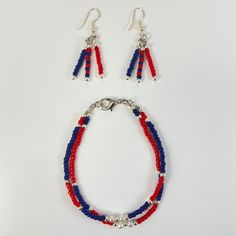 Friendship Bracelet - Complimentary blue and red beads accented by interspersed silver round beads. Silver lobster claw closure. Beautiful matching dangling earrings on silver fish hook. Patriotic Red Beaded Bracelets, Patriotic Blue Dangle Jewelry, Patriotic Multicolor Bracelet Jewelry, Red Patriotic Bracelet Jewelry, Patriotic Blue Round Bead Jewelry, Patriotic Jewelry, Red Bead, Fish Hook, Boutique Jewelry