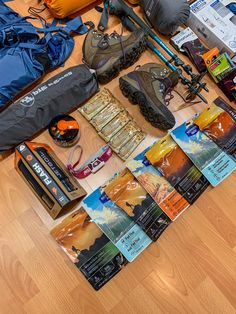 various items laid out on the floor to be used as camping gear and backpacks