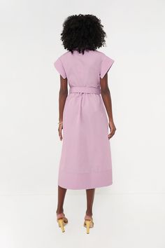 Elegant in its simplicity, the structured and ultra-ladylike Lilac Chloe Dress is done in a textured cotton-blend fabric that is sure to turn heads for its design details. The moire pattern throughout and trapunto stitching on the sleeves, placket, and hemline complete this midi moment, making it feel extra special with minimal effort. Pair with heels or flats, sunnies or statement earrings, for day or night, and rest assured that you look fabulous! Spread collar Short wing sleeves Button front placket Optional adjustable fabric belt with buckle closure (included) Side seam pockets Trapunto stitching on sleeves, placket, and hemline Midi length Moire fabric Material: 80% Polyester, 20% Cotton Care: Dry clean only Modern Fitted Cotton Dresses, Structured Short Sleeve Spring Dress, Structured Short Sleeve Dress For Spring, Cotton Fitted Maxi Dress For Work, Fitted Cotton Maxi Dress For Work, Structured Spring Workwear Dresses, Fitted Feminine Cotton Shirt Dress, Knee-length Cotton Midi Dress For Work, Cotton Dress With French Seams For Work