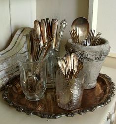 silverware and utensils are sitting on a tray