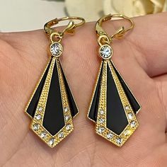 These gorgeous Art Deco inspired earrings are all solid silver with a beautiful gold vermeil. Black enamel and cubic zirconia stones that sparkle in any lighting. These earrings are by Vintage Amara. These earrings are brand new and come gift wrapped so you don't have to! These earrings also come in a silver colour- listed separately. Earring drop length: 4cm. Earring width: 1.5cm. Clearly marked: 925. www.vintageamara.co.uk Gold Art Deco Earrings For Party, Art Deco Yellow Gold Earrings For Evening, Art Deco Evening Earrings With Diamond Accents, Art Deco Gold Jewelry With Cubic Zirconia, Art Deco Gold Cubic Zirconia Jewelry, Black Art Deco Earrings For Evening, Gold Black Enamel Earrings For Evening, Gold Earrings With Black Enamel For Evening, Art Deco Cubic Zirconia Earrings Gift