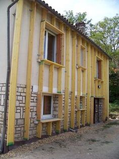 an unfinished house is being built on the side of a road