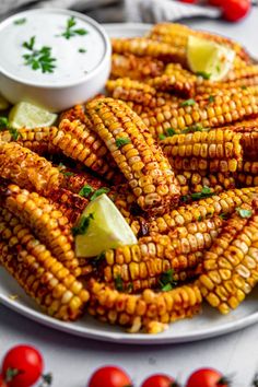 grilled corn on the cob with sour cream and fresh herbs for garnish