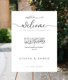 a welcome sign for the newly married couple in arabic calligraphy on an easel