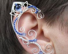 a person with ear piercings made to look like an intricate piece of art work