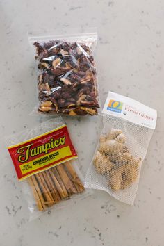 two bags of food sitting on top of a counter next to an orange and white bag