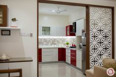 the interior of a kitchen with red and white decor on the walls, flooring and cabinets