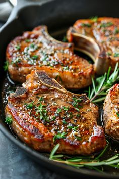 steaks with herbs and seasoning in a skillet