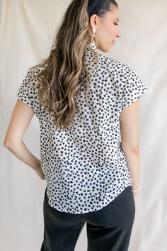 The Sofia blouse features a flowy button-up style with a feminine ruffle collar. Just unbutton the first few buttons, and you've got easy nursing access. For a cropped look, tie the bottom into a knot. Cut from airy cotton, this black and white printed blouse features pretty abstract flowers. A customer's print favorite: available in the Gaelle Wrap Blouse. Size Guide Details Shipping XS - (0) | Bust 32-33 | Waist 24-26 | Hip 34-35 S - (2-4) | Bust 34-35 | Waist 27-28 | Hip 36-37 M - (6-8) | Bus Versatile Collared Rayon Blouse, Effortless Rayon Blouse For Spring, Effortless Spring Rayon Blouse, Spring Tie Neck Top With Button Closure, Spring Tie-neck Top With Button Closure, Spring Tie Neck Tops With Button Closure, Casual Tie Neck Shirt For Workwear, Spring Casual Blouse With Buttons, Spring Casual Buttoned Blouse