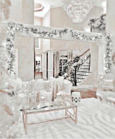 a living room filled with furniture and a chandelier