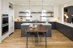 a kitchen with an island and wooden floors