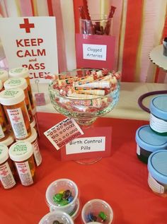 a table topped with lots of candy and candies on top of a red table cloth