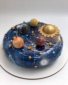 a cake decorated with planets and stars on a plate