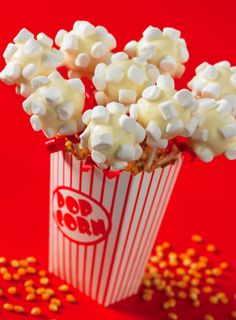 popcorn with marshmallows in a paper cup on a red tablecloth and sprinkles