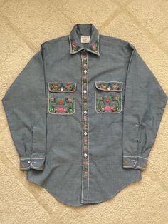 Hand embroidered permanent press chambray shirt.  Mens Small shirt size. Beautiful embroidery.  Like new. Casual Fitted Shirt With Multicolor Embroidery, Fitted Casual Shirt With Multicolor Embroidery, Traditional Fit Embroidered Shirt For Spring, Spring Embroidered Traditional Fit Shirt, Spring Cotton Tops With Traditional Fit, Traditional Fit Cotton Tops For Spring, Classic Cotton Shirt With Floral Embroidery, Casual Embroidered Shirt Traditional Fit, Casual Embroidered Shirt With Traditional Fit