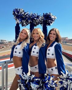 three cheerleaders are posing for the camera