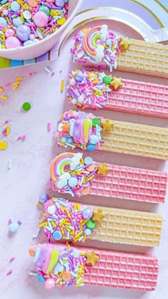 there are waffles with sprinkles on them next to a bowl of confetti