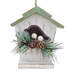 a birdhouse with pine cones and balls on it