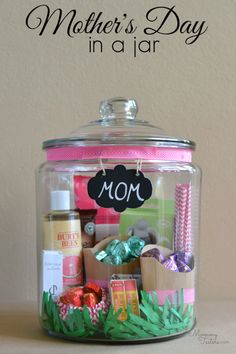 a jar filled with lots of different types of items and the words mother's day in a jar