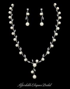 a necklace and earring set with pearls on the side, in white gold plated