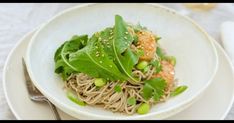 a white plate topped with noodles and vegetables