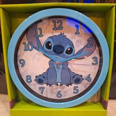 a blue and green clock with a cartoon character on it