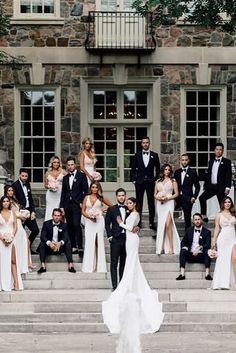 a group of people in formal wear standing on steps