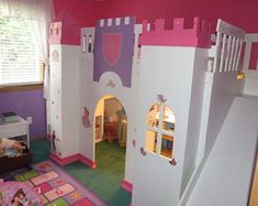 this is a bedroom with a princess castle bed in the corner and a door to another room