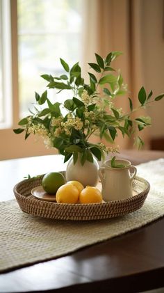 a tray with lemons, limes and flowers on top of a wooden table